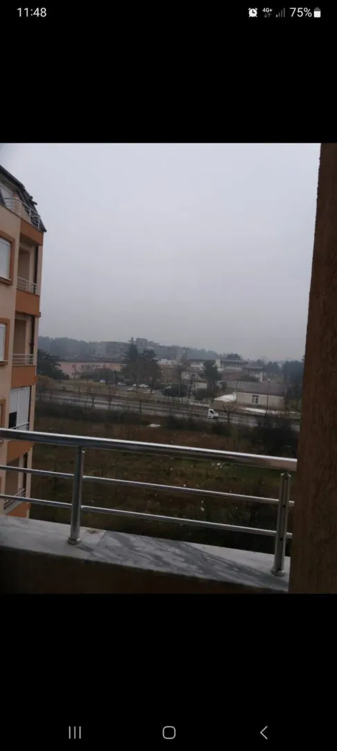 View from the balcony overlooking the street and nearby buildings.