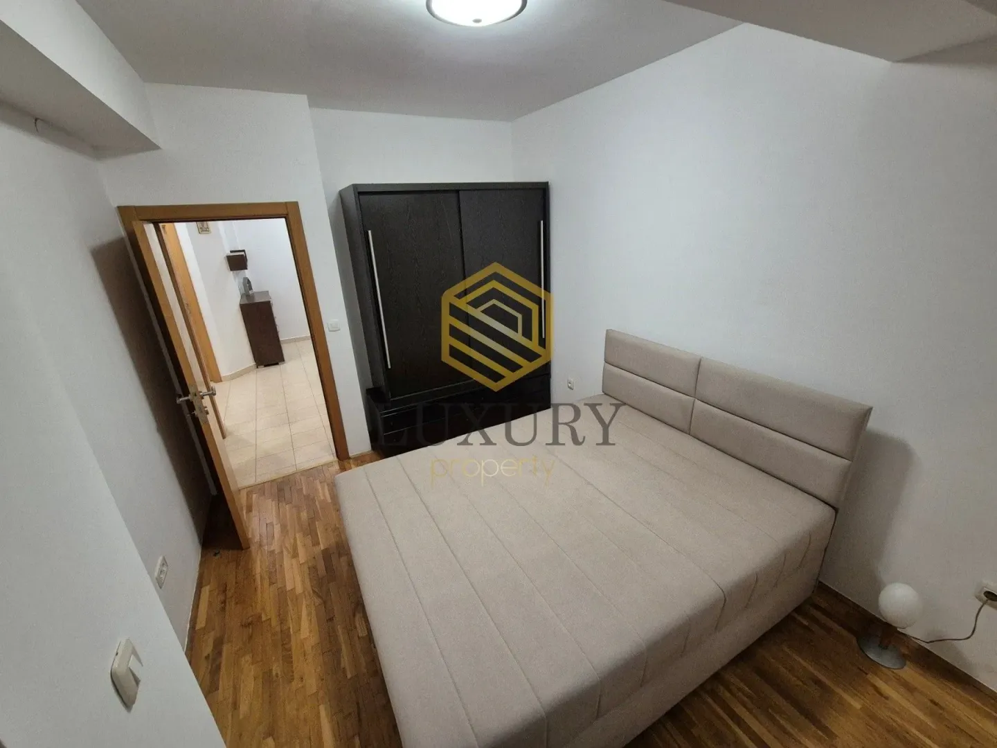 Furnished bedroom with a double bed and wardrobe.