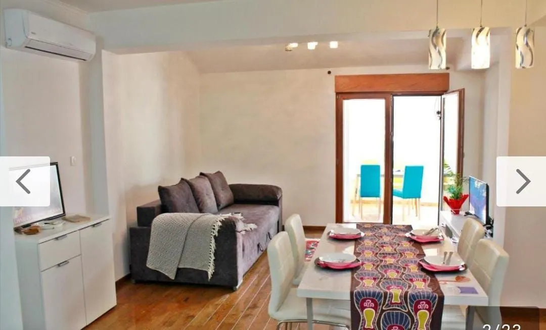 Living room with dining area and sofa set.