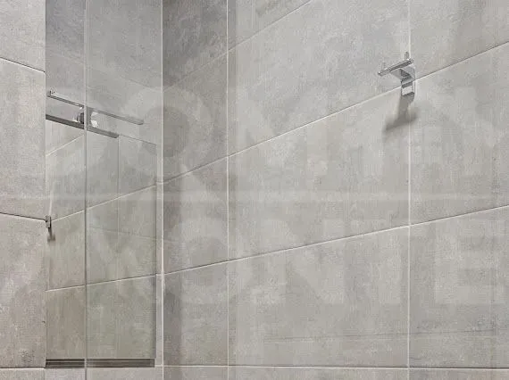 Bathroom detail with grey tiles and a built-in mirror.