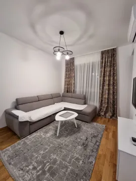 Living room with a sectional sofa, coffee table and TV unit. - image 9