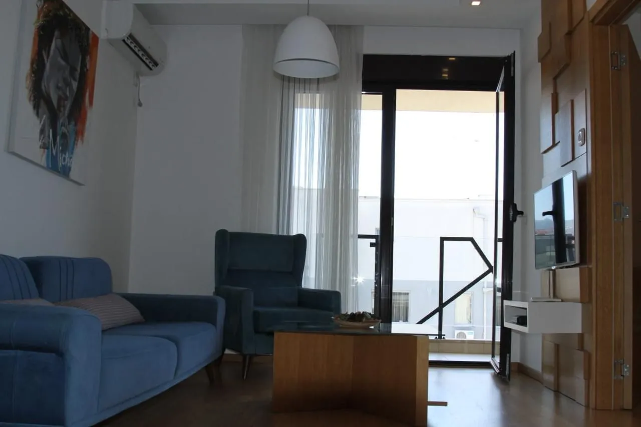 Living room with a sofa, coffee table and access to the terrace.