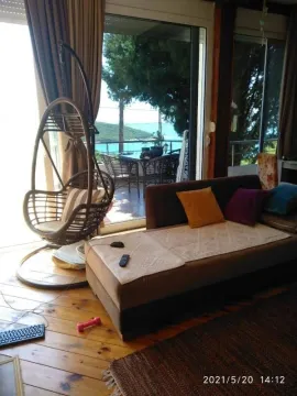 Living room with seating furniture and a sea view. - image 3