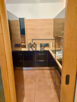 View from the hallway into a small equipped kitchen. - image 3