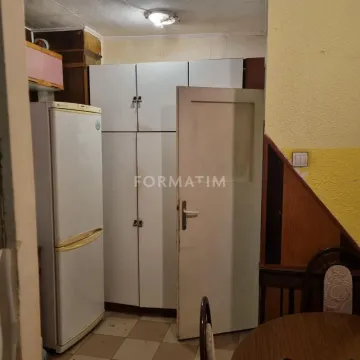 Kitchen with a refrigerator, fitted units, and a door. - image 7