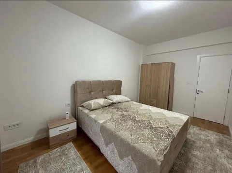 Furnished bedroom with a double bed, wardrobe, and nightstand. - image 4