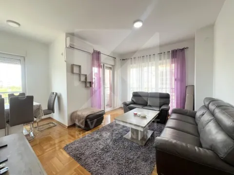 Spacious living room with a sofa set, coffee table, and dining area in the background. - image 3