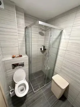Modern bathroom with a walk-in shower. - image 13