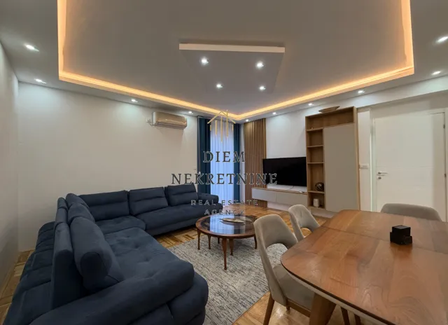 Modern living room with a sofa and dining table.