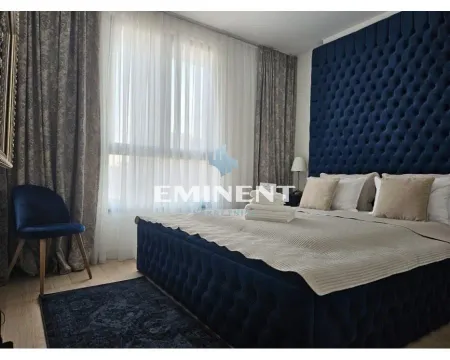 Spacious bedroom with a large double bed and an upholstered headboard. - image 8