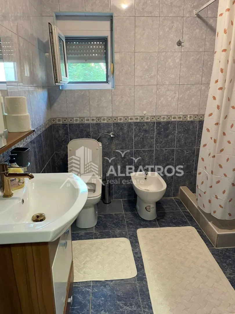 Bathroom with a washbasin, toilet, bidet, and shower cabin.