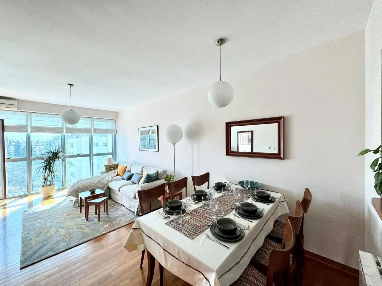 Spacious living room with a dining area and large windows.
