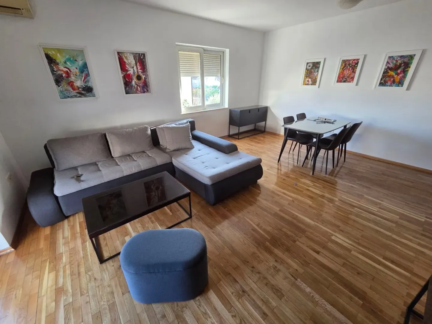 Living room with a sofa and a dining area.