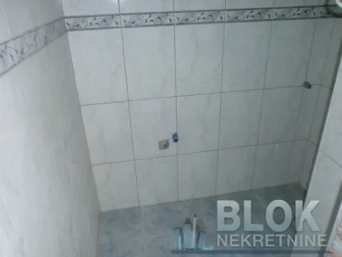 Bathroom lined with ceramic tiles and prepared plumbing connections for sanitary fixtures. - image 7