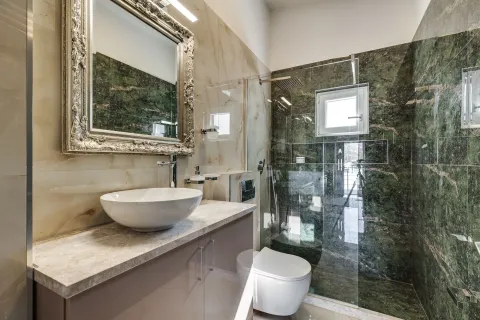 Moderne kupatilo sa umivaonikom, ugradnim wc šoljom i tuš kabinom obloženom kamenim pločicama. - image 10
