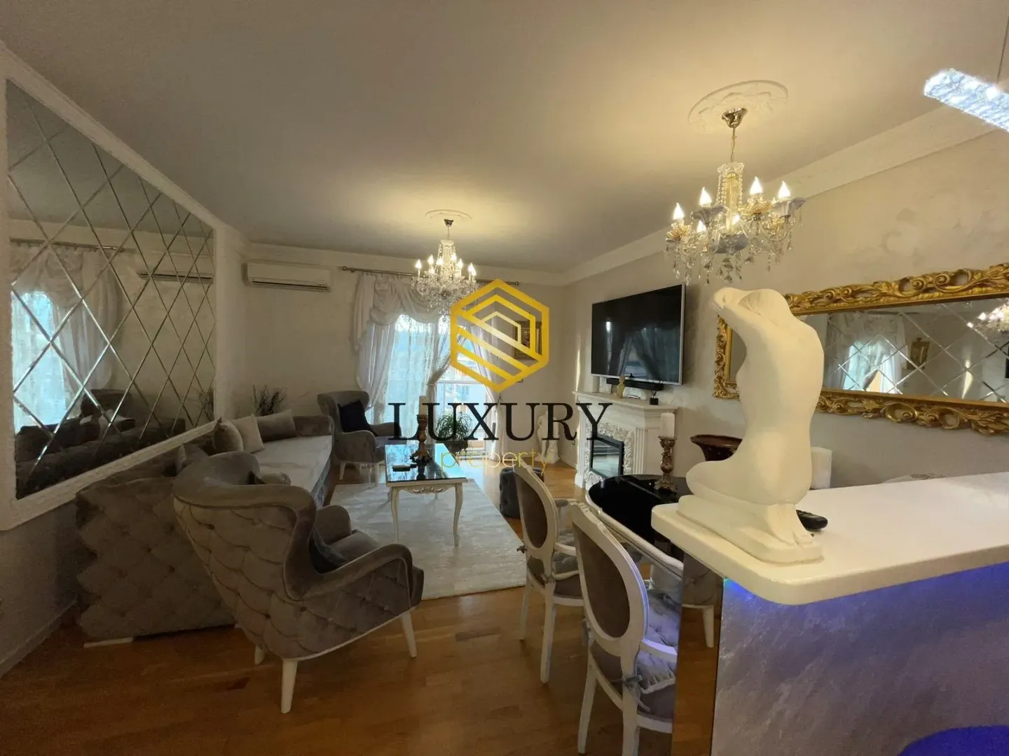 Spacious living room with seating area, fireplace, and dining space.