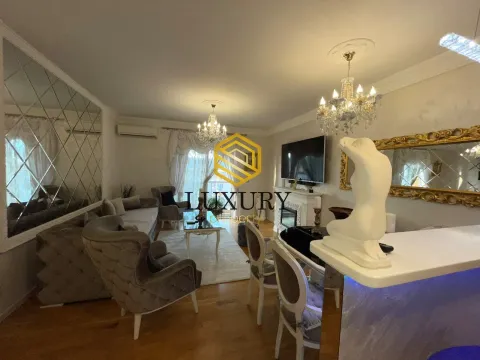Spacious living room with seating area, fireplace, and dining space. - image 8