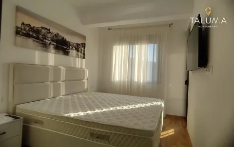 Bedroom with a double bed, wall art and a television. - image 5