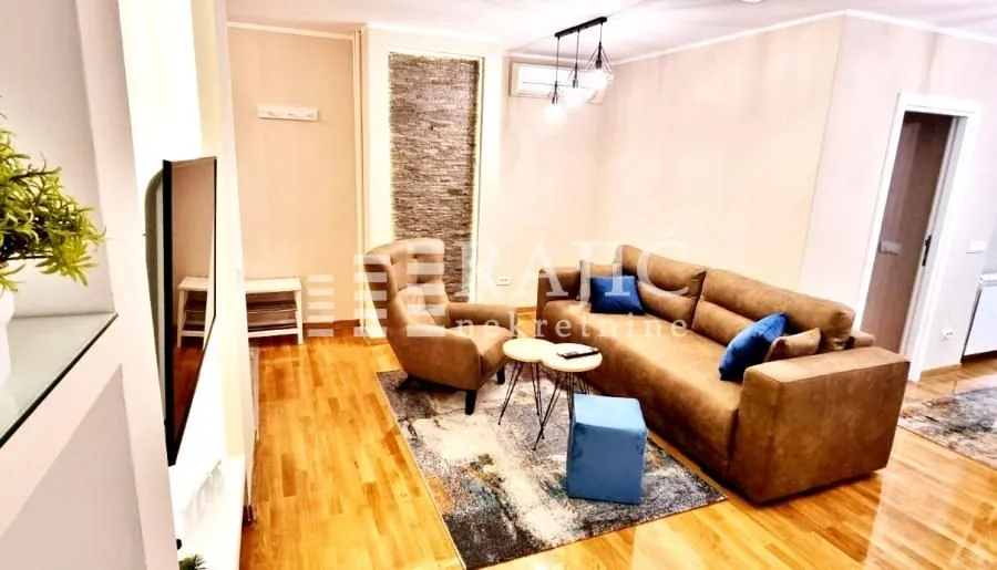 Living room with a sofa set and hardwood flooring.