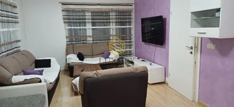 Living room with sofa set, TV and a purple wall. - image 8