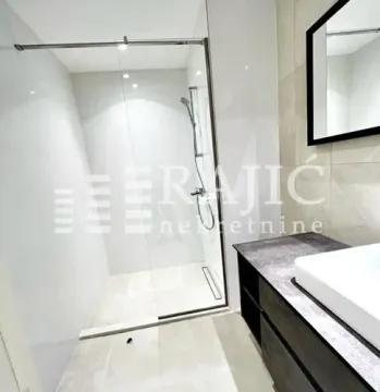 Modern bathroom with walk-in shower and washbasin. - image 9