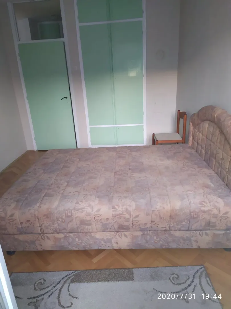 A simple bedroom featuring a double bed and built-in wardrobes.