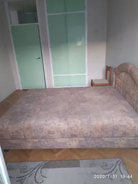 A simple bedroom featuring a double bed and built-in wardrobes. - image 6