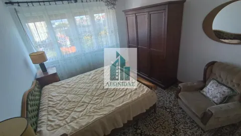 Furnished bedroom with a double bed, wardrobe, and an armchair. - image 12