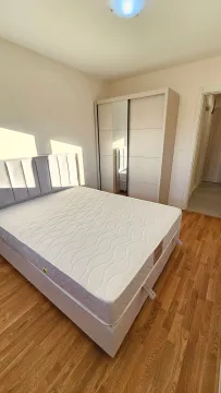 Bright bedroom with a double bed and a wardrobe. - image 8