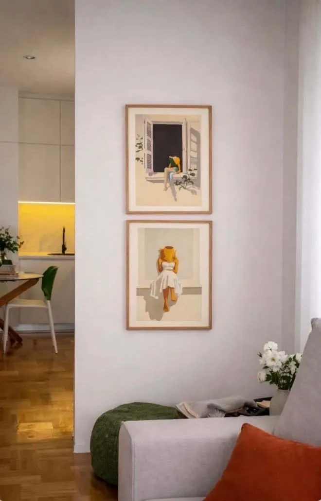 Living room with a sofa and paintings on the wall.