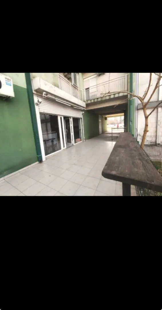 View of the exterior space and business premises entrance with a paved courtyard.