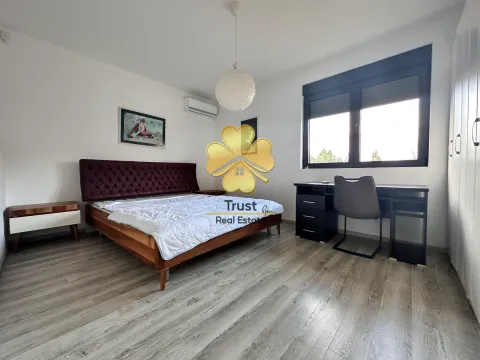 Furnished bedroom with a double bed, desk, and wardrobe. - image 15