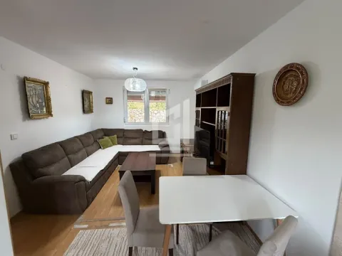 Living room with a sectional sofa, dining table, and wooden furniture. - image 4