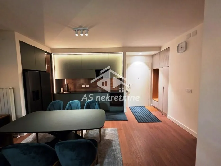 Modern kitchen connected to the dining area and entrance hallway.
