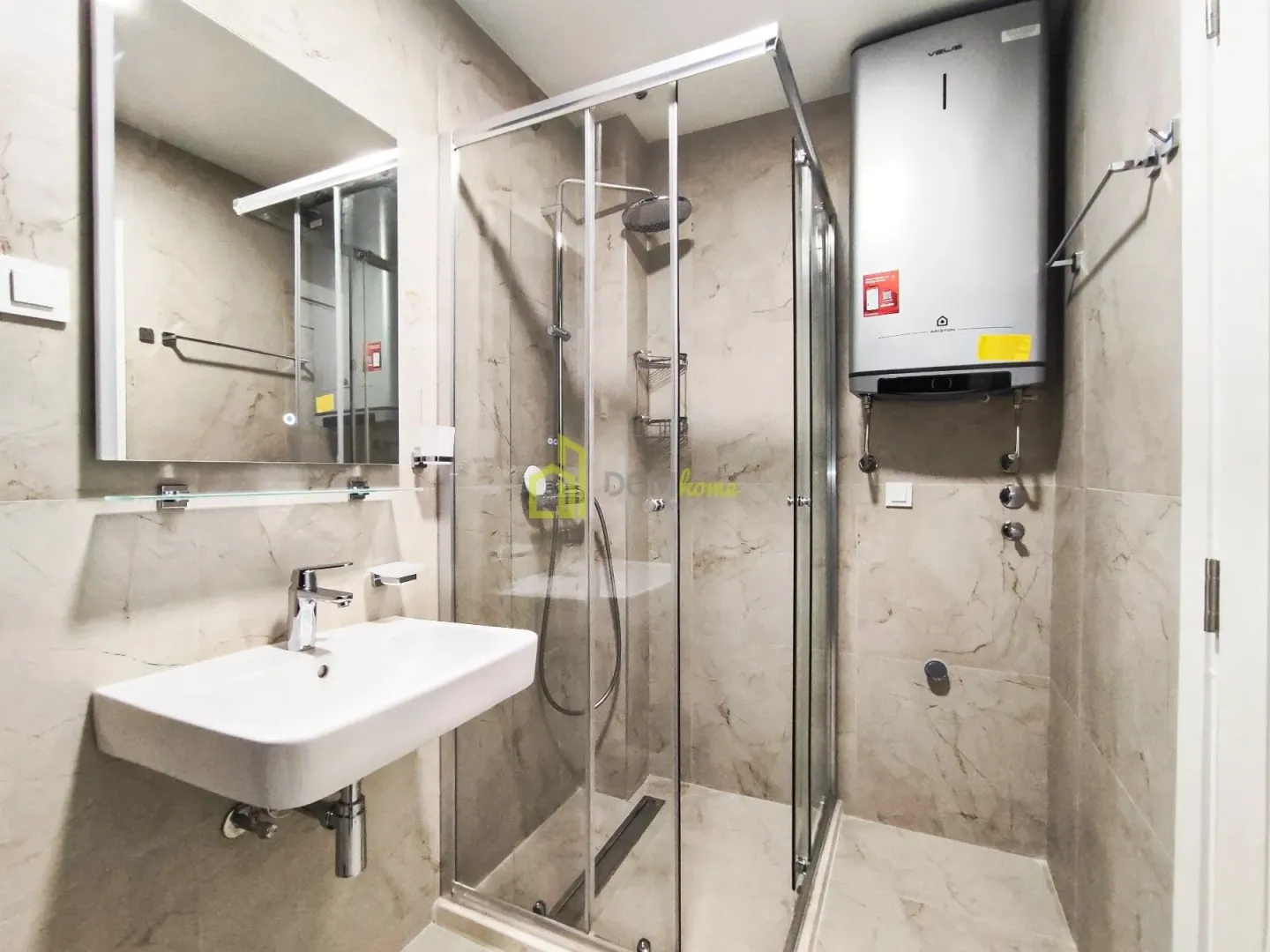 Bathroom with a sink, mirror, and shower cabin.