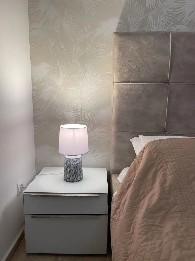 Bedroom detail featuring a bed and a nightstand.