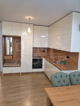 Modern kitchen with white cabinets and wooden details. - image 4