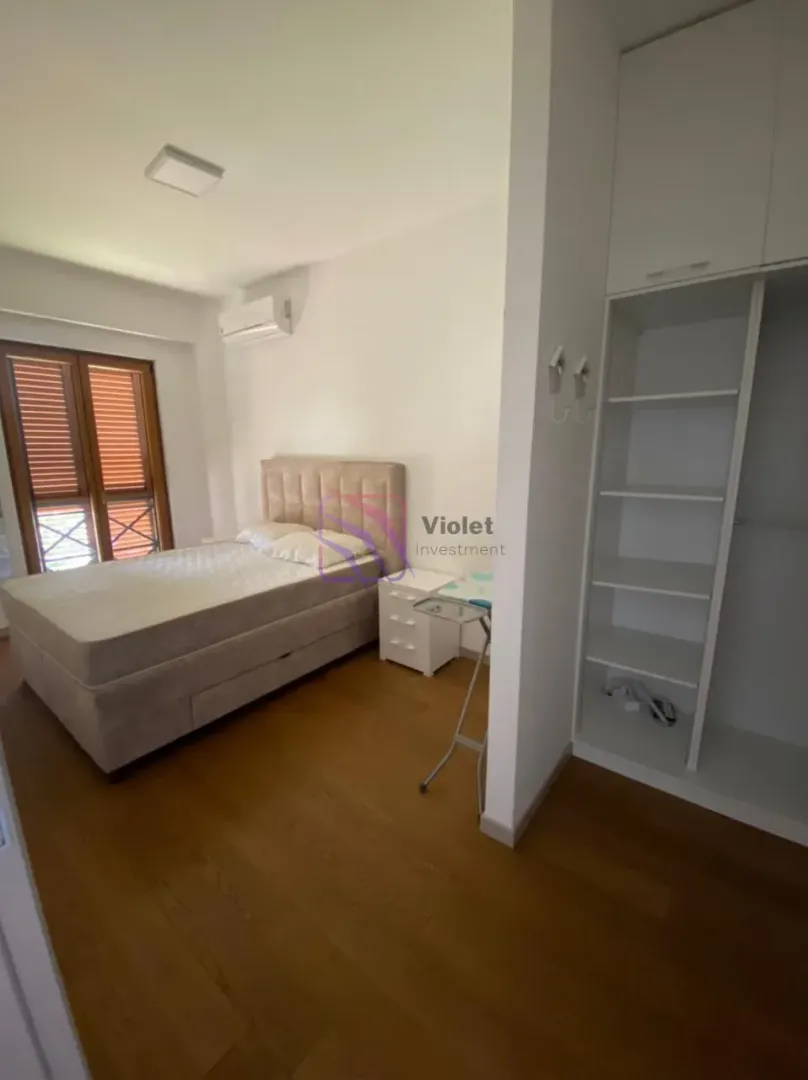 Furnished bedroom with a double bed, wardrobe, and a window.