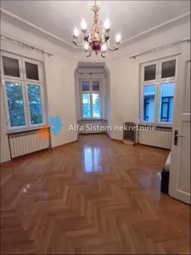 Empty living room with parquet flooring, large windows, and a chandelier. - image 4