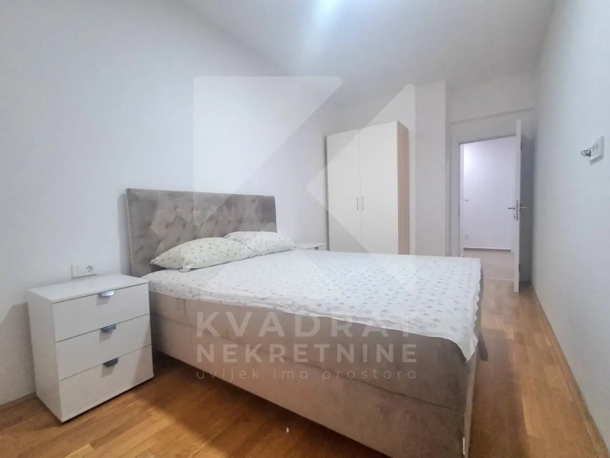 Bedroom with a double bed, bedside table, and wardrobe.