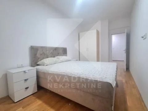 Bedroom with a double bed, bedside table, and wardrobe. - image 4