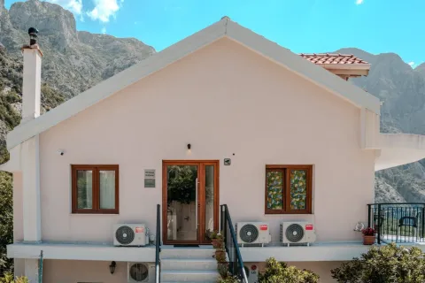 Prednji pogled na dvospratnu kuću sa terasom i planinskim pejzažem u pozadini. - image 10