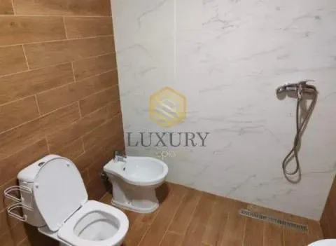 Modernly equipped bathroom with a shower, toilet, and bidet. - image 17