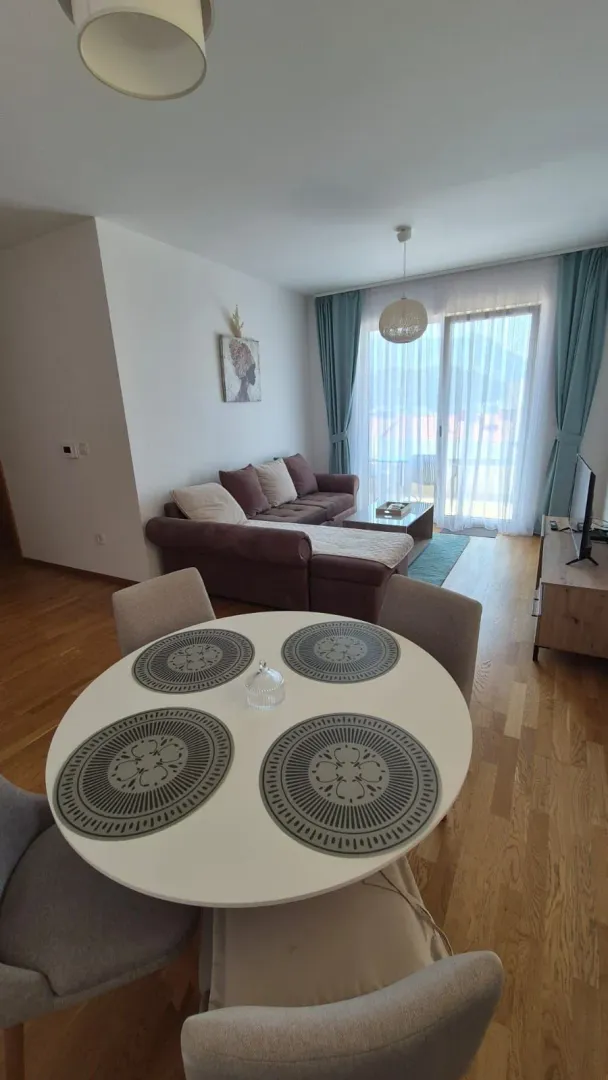 Living room with a dining table and sofa set.