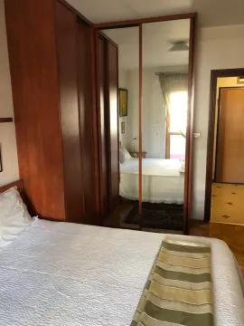 Bright bedroom featuring a large built-in wardrobe with mirrored doors. - image 11