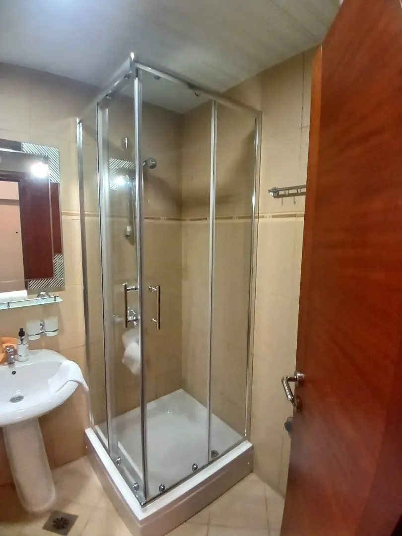 Small bathroom with a shower cabin and washbasin.