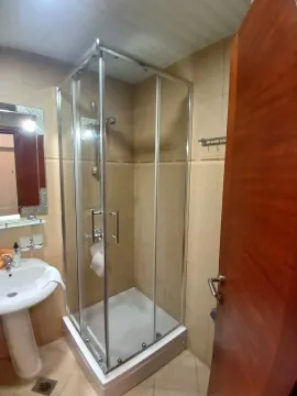 Small bathroom with a shower cabin and washbasin. - image 4