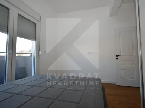 Bedroom with a bed, white walls and access to the terrace. - image 7