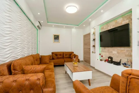 Modern living room with brown sofa set and wall-mounted TV. - image 2