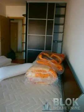 Bedroom with a bed and a built-in wardrobe. - image 7